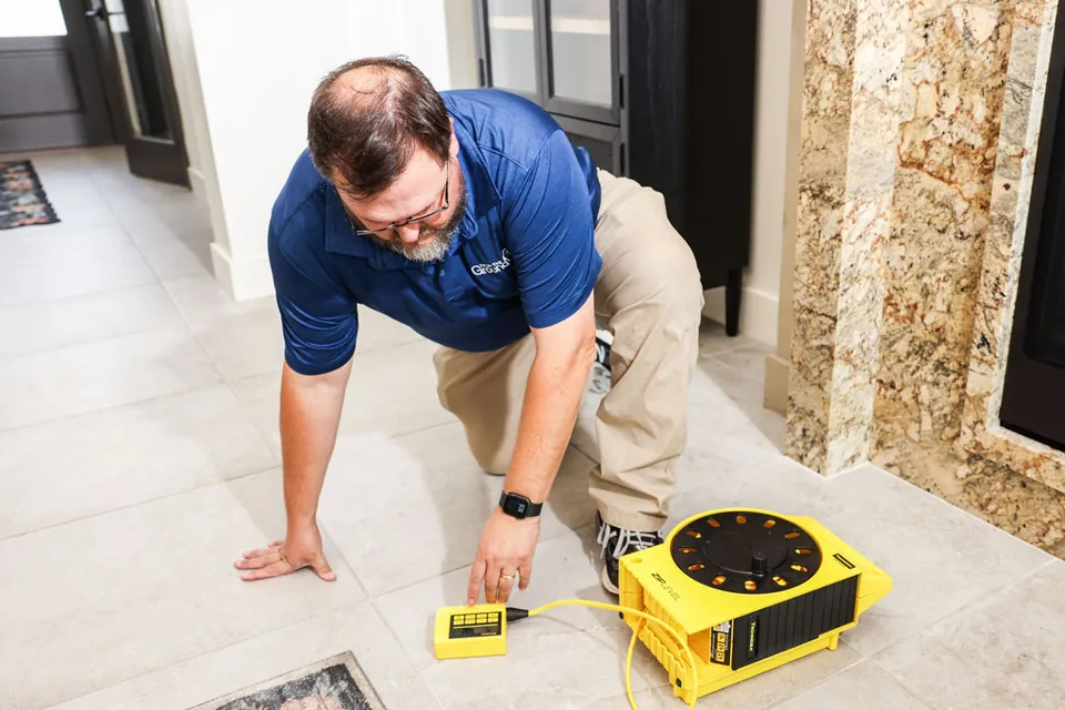 FTGU performing foundation elevation measurements inside a home